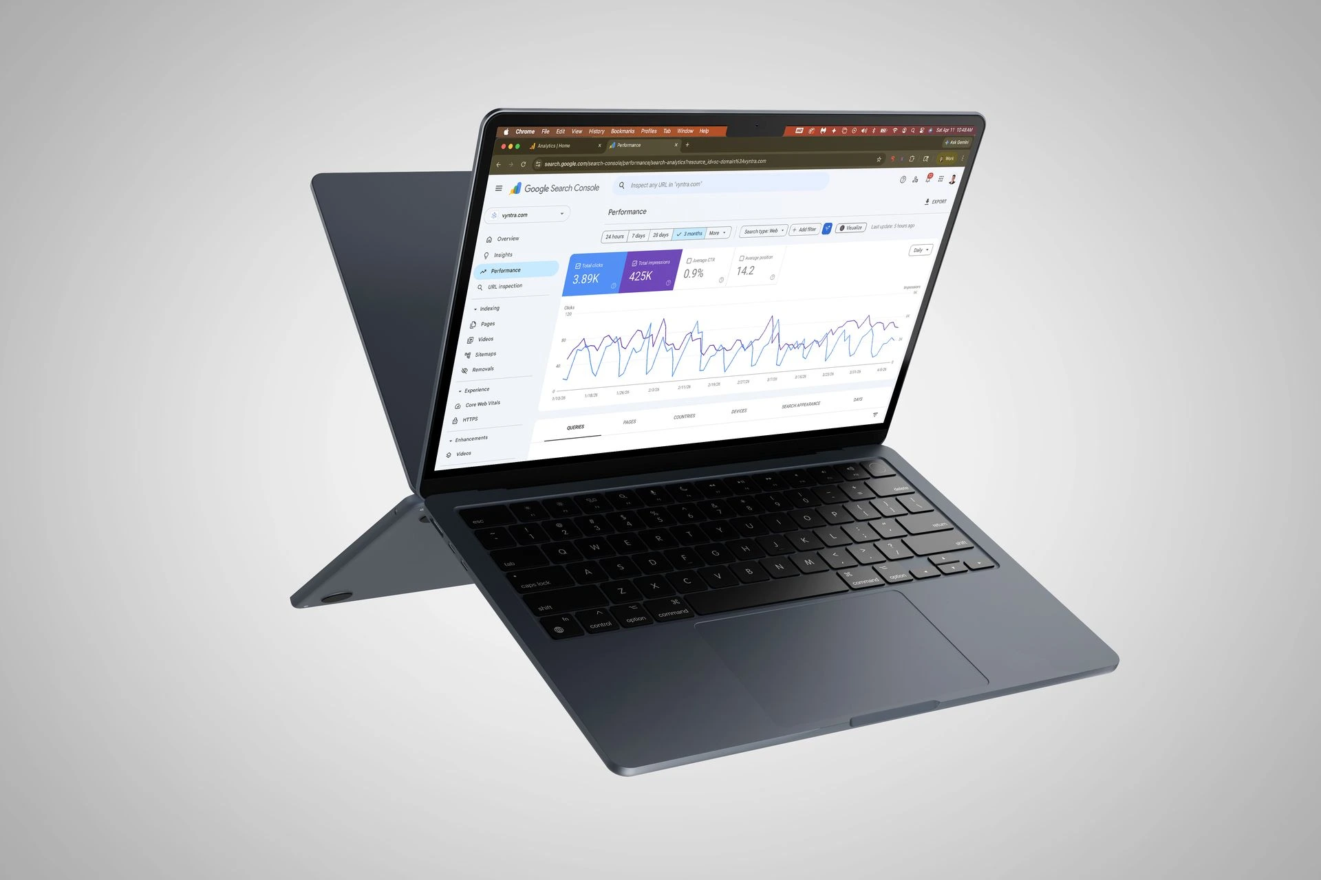 Back to back laptops displaying digital marketing stats