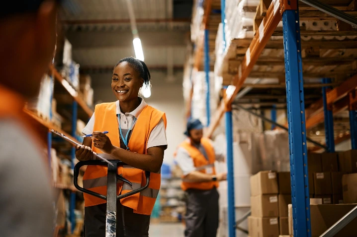 Happy warehouse staff with a synced order and inventory data