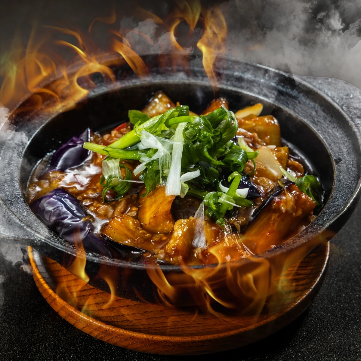 A cast iron pot on fire